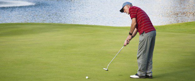 A man is playing golf on the green